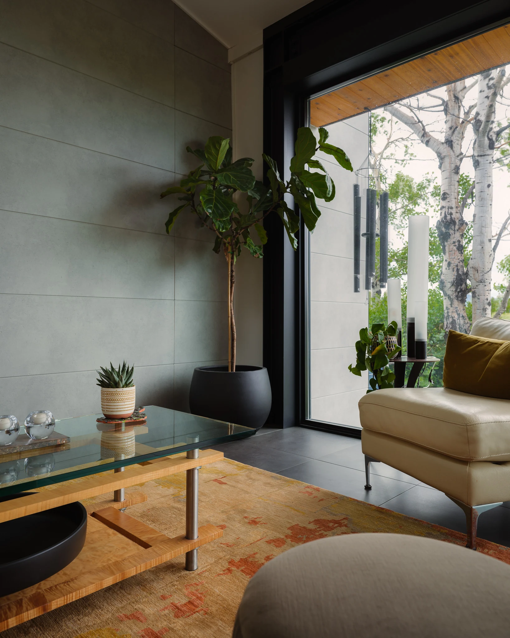 Living room corner with floor-to-ceiling glass and hanging wind chimes — architectural photography Bozeman Montana, Bozeman Overlook